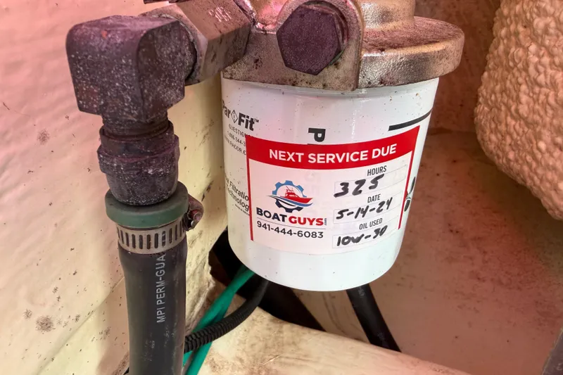 Slide: The Image of Oil filter with service label on a 2018 Yellowfin 21 Bay boat. - 25