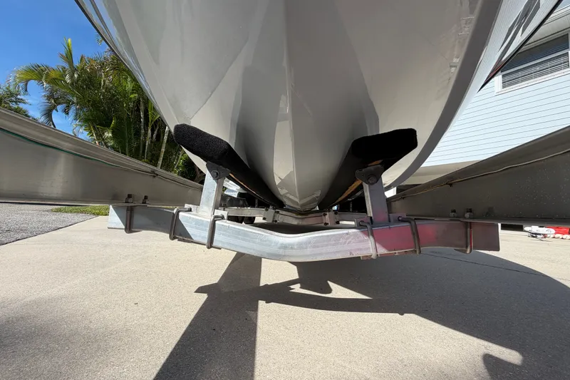 Slide: The Image of 2018 Yellowfin 21 Bay boat on trailer, viewed from below, with palm trees in background. - 4