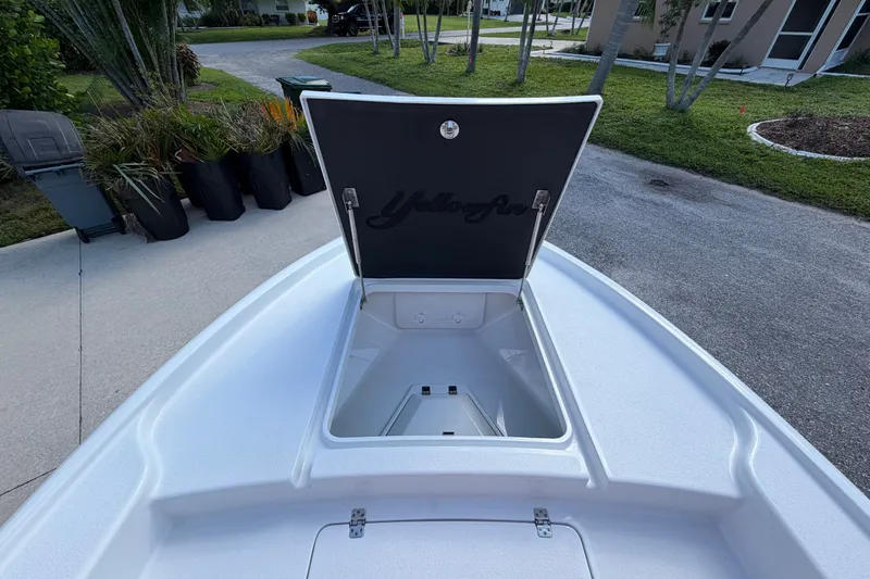 Slide: The Image of 2018 Yellowfin 21 Bay boat with open storage compartment on driveway. - 38