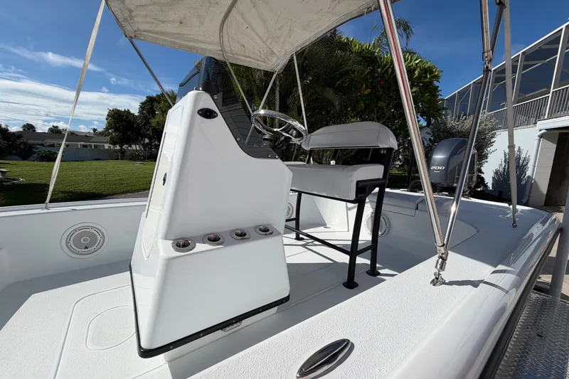 Slide: The Image of 2018 Yellowfin 21 Bay boat interior with console and seating under canopy. - 32