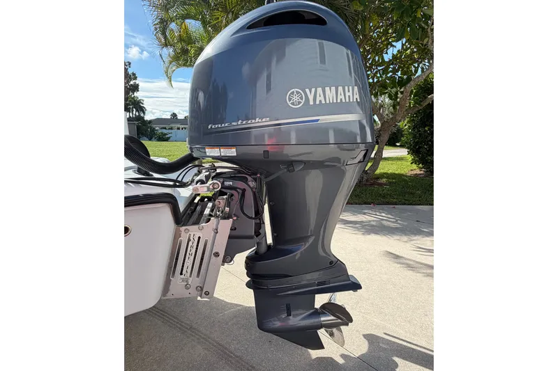 Slide: The Image of 2018 Yellowfin 21 Bay with Yamaha four-stroke outboard motor, parked outdoors. - 10