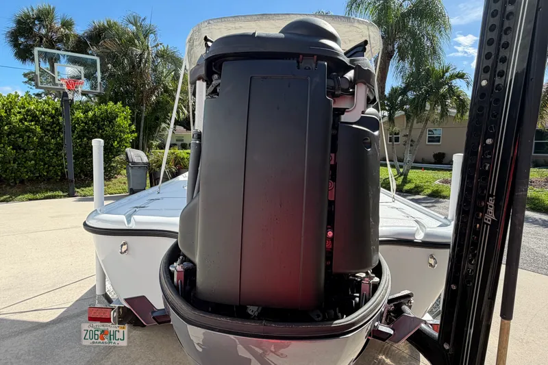 Slide: The Image of 2018 Yellowfin 21 Bay boat with outboard motor in a sunny driveway. - 13