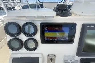 Slide: The Image of Dashboard of a 2000 Pursuit 2870 Offshore Center Console boat with navigation instruments. - 8