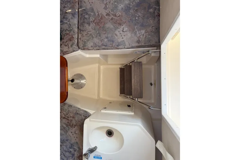 Slide: The Image of Interior view of a 2000 Pursuit 2870 Offshore Center Console boat cabin. - 9
