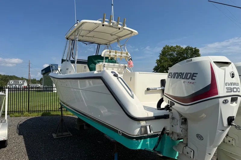 Slide: The Image of 2000 Pursuit 2870 Offshore Center Console boat with Evinrude engine on display. - 2