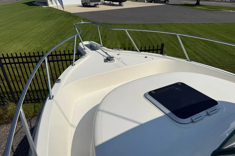 Slide: The Image of 2000 Pursuit 2870 Offshore Center Console boat deck with railing and hatch. - 12