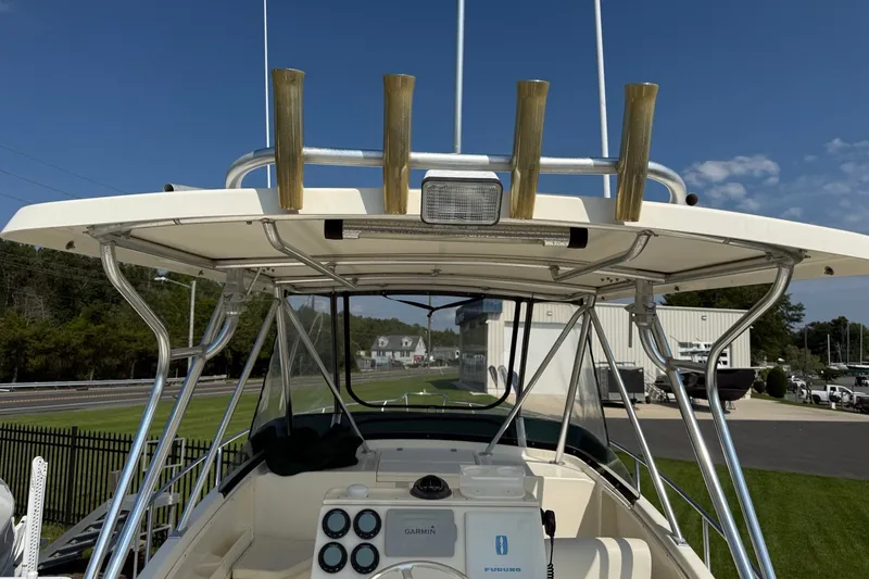 Slide: The Image of 2000 Pursuit 2870 Offshore Center Console boat with T-top and rod holders. - 7