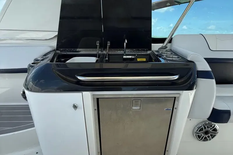 Slide: The Image of 2022 Formula 350 Crossover Bowrider boat kitchen area with sink and storage. - 17