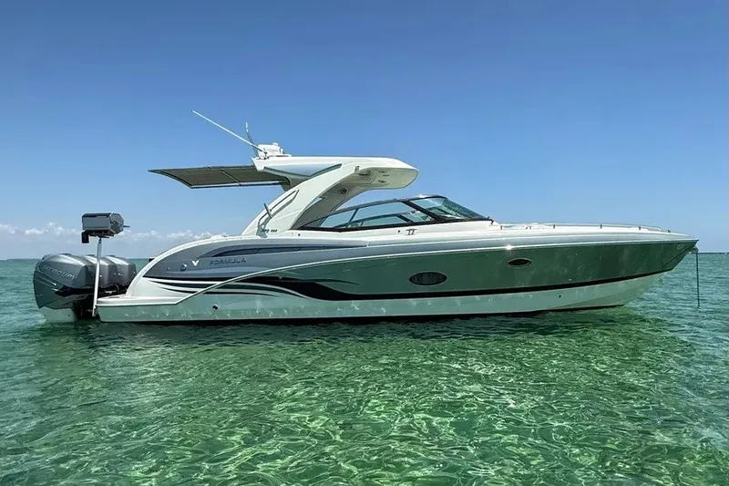 Slide: The Image of 2022 Formula 350 Crossover Bowrider on clear water under blue sky. - 5
