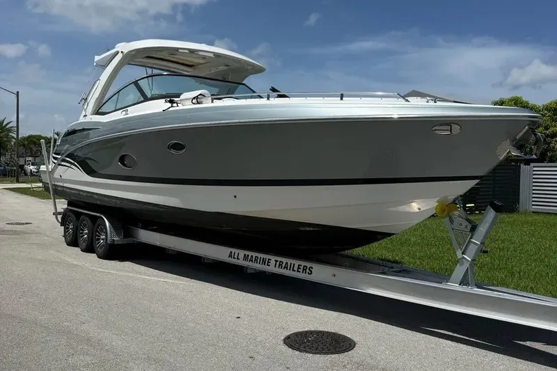 Slide: The Image of 2022 Formula 350 Crossover Bowrider on trailer, parked outdoors under clear sky. - 1