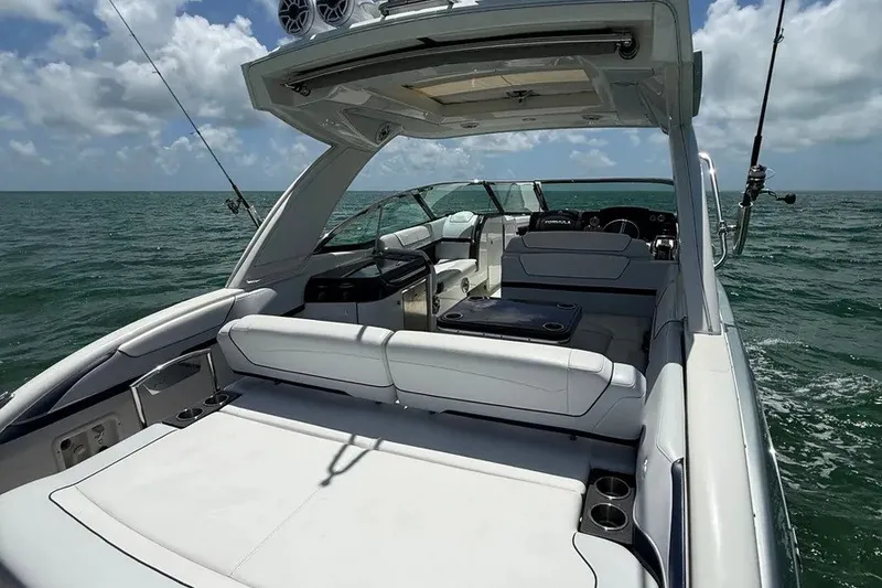 Slide: The Image of 2022 Formula 350 Crossover Bowrider on open water, featuring spacious seating and sleek design. - 9