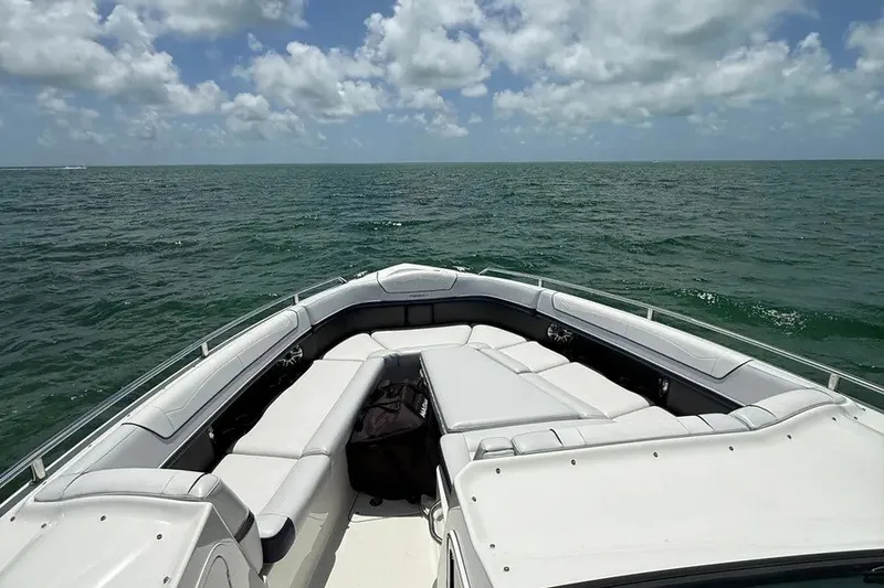 Slide: The Image of 2022 Formula 350 Crossover Bowrider on open water under a partly cloudy sky. - 10