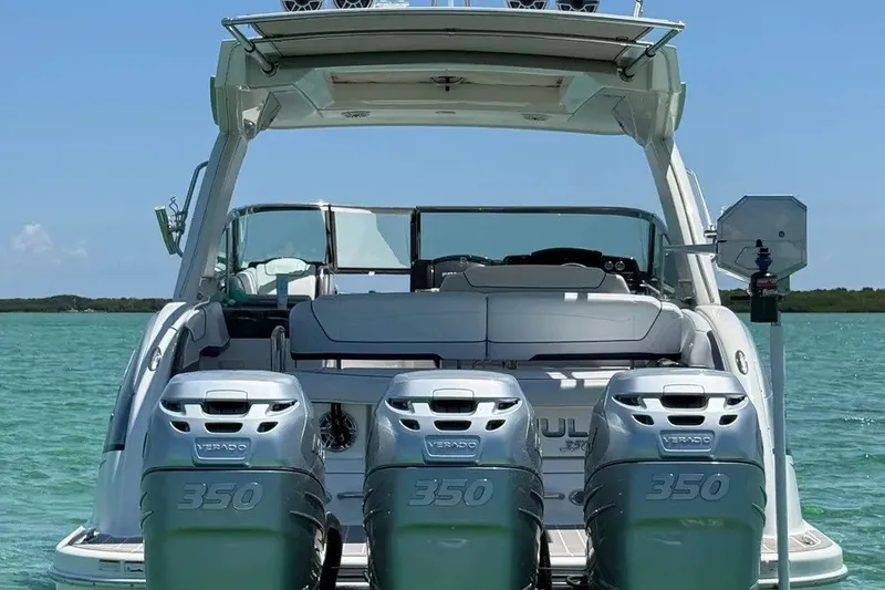 Slide: The Image of 2022 Formula 350 Crossover Bowrider with triple Verado 350 engines on turquoise water. - 7