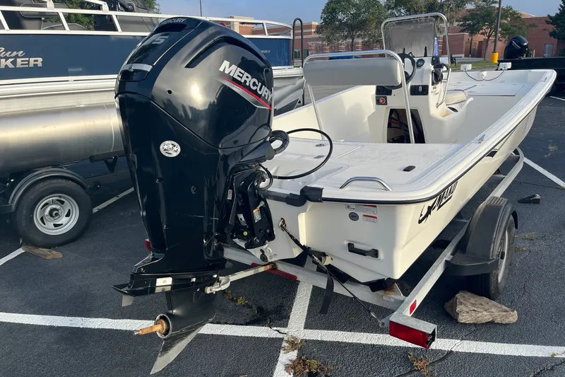 Slide: The Image of 2021 Mako Pro Skiff 17 CC boat with Mercury outboard motor on trailer. - 6