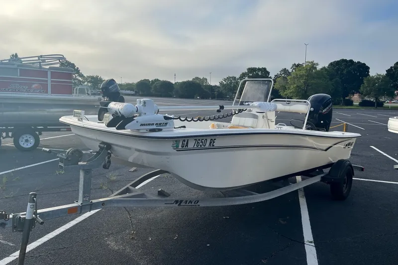 Slide: The Image of 2021 Mako Pro Skiff 17 CC boat on trailer in parking lot. - 1