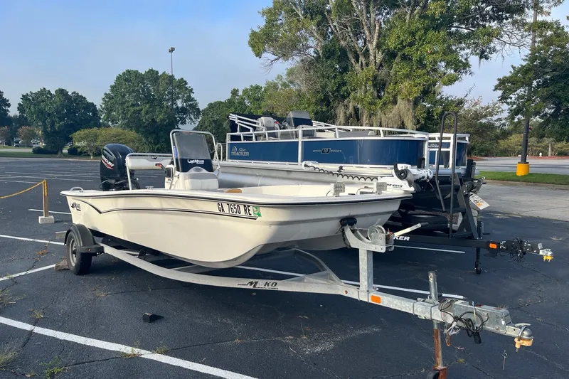 The Image of 2021 Mako Pro Skiff 17 CC boat on trailer in parking lot. - 0