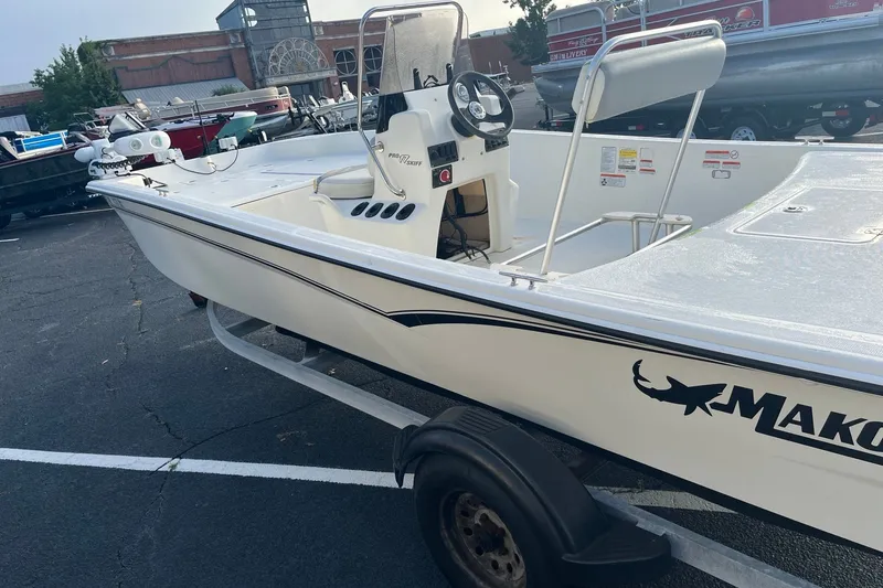 Slide: The Image of 2021 Mako Pro Skiff 17 CC boat on trailer in parking lot. - 4
