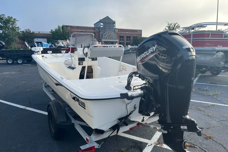 Slide: The Image of 2021 Mako Pro Skiff 17 CC boat with Mercury engine in a parking lot. - 5