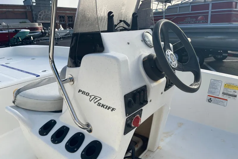 Slide: The Image of 2021 Mako Pro Skiff 17 CC boat console with steering wheel and controls. - 3