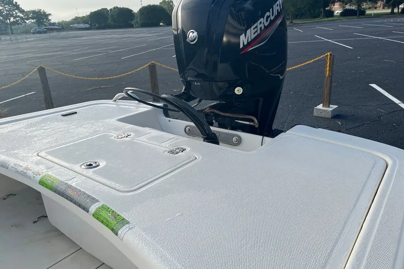 Slide: The Image of 2021 Mako Pro Skiff 17 CC with Mercury outboard motor in parking lot. - 2