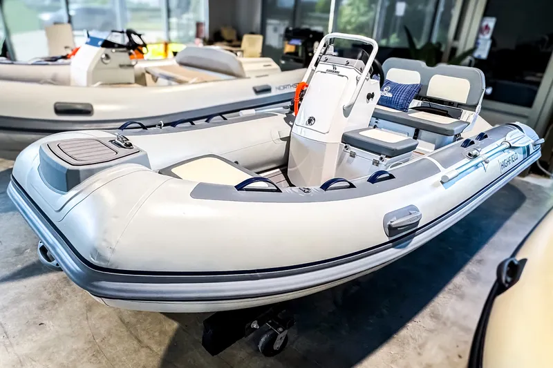 The Image of 2026 Highfield Classic 380 GT inflatable boat in showroom, featuring modern design and seating. - 0