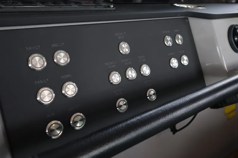 Slide: The Image of Control panel of 2024 Aquador 300 HT boat with labeled buttons and switches. - 21