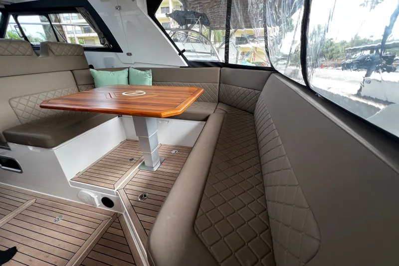 Slide: The Image of Luxurious interior of 2024 Aquador 300 HT boat with elegant seating and wooden table. - 40