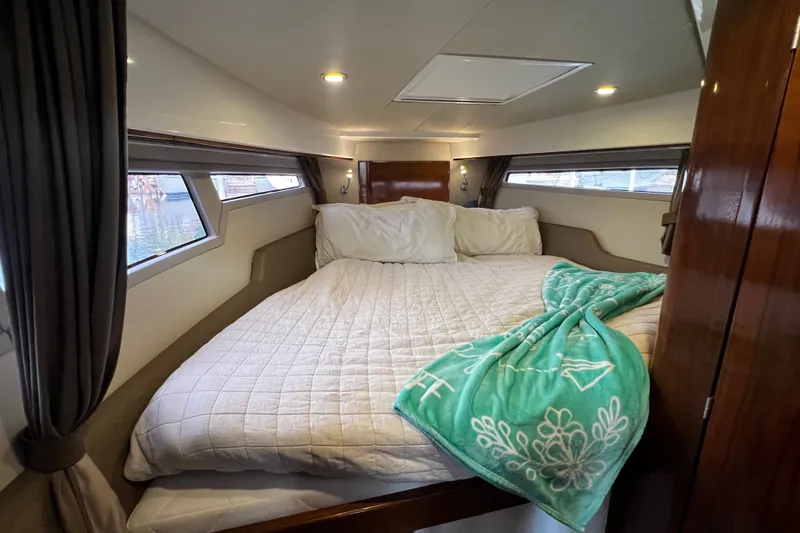 Slide: The Image of Luxurious cabin interior of 2024 Aquador 300 HT with cozy bedding and ambient lighting. - 44