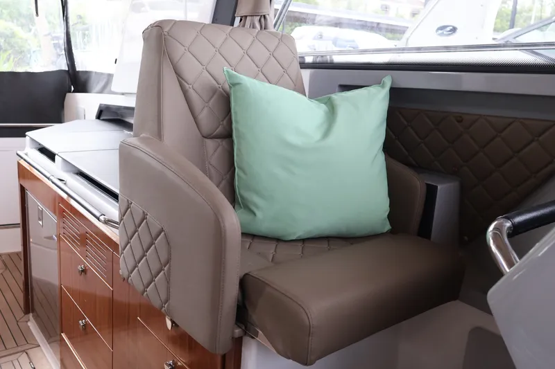 Slide: The Image of Luxurious interior of 2024 Aquador 300 HT boat with quilted seating and mint cushion. - 25
