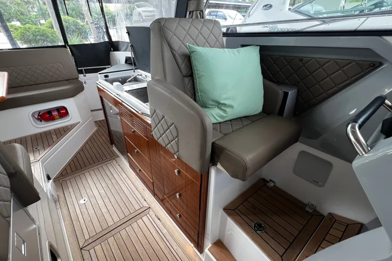 Slide: The Image of Luxurious interior of 2024 Aquador 300 HT boat with elegant seating and wooden cabinetry. - 26