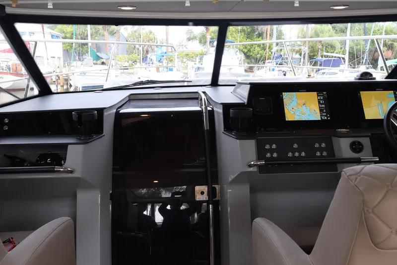 Slide: The Image of Interior cockpit of 2024 Aquador 300 HT boat with navigation screens and controls. - 16