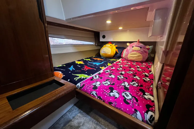 Slide: The Image of Cozy cabin in 2024 Aquador 300 HT with colorful bedding and plush toys. - 48