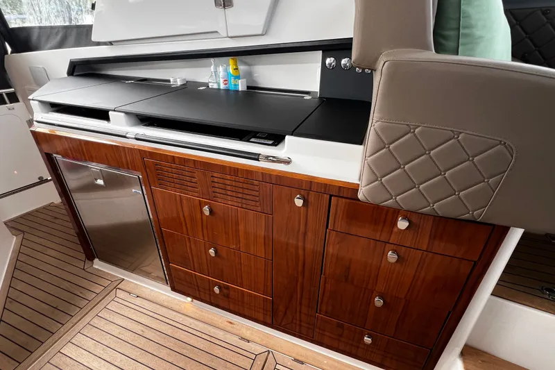 Slide: The Image of Luxurious interior of 2024 Aquador 300 HT yacht with wooden cabinetry and modern amenities. - 34
