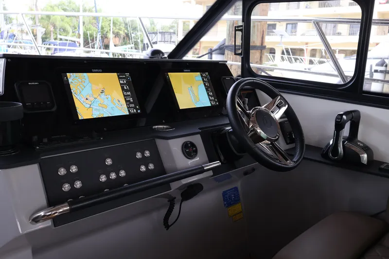 Slide: The Image of 2024 Aquador 300 HT helm with dual navigation screens and modern controls. - 15