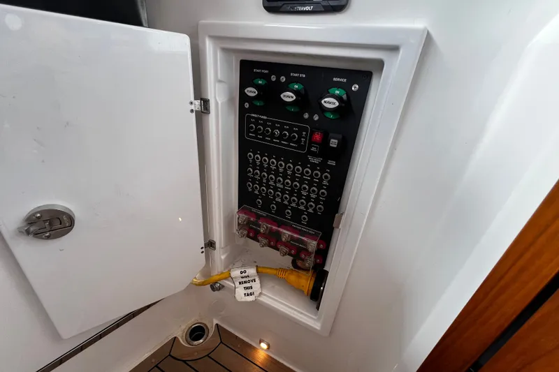 Slide: The Image of Electrical panel inside 2024 Aquador 300 HT boat, featuring switches and wiring. - 37