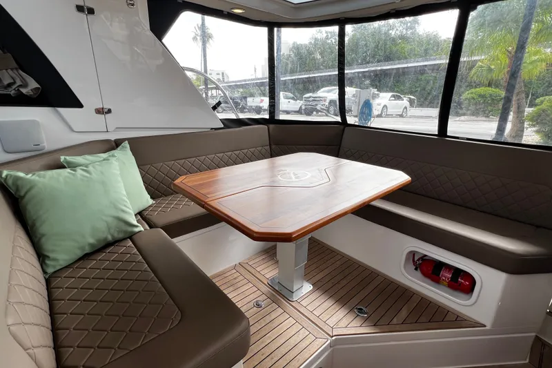Slide: The Image of Luxurious interior of 2024 Aquador 300 HT boat with elegant seating and wooden table. - 38