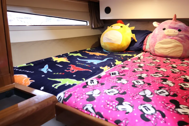 Slide: The Image of Cozy cabin beds with colorful dinosaur and character-themed blankets in 2024 Aquador 300 HT. - 50