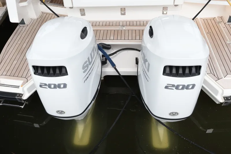 Slide: The Image of Twin Suzuki 200 outboard engines on a 2024 Aquador 300 HT boat. - 63