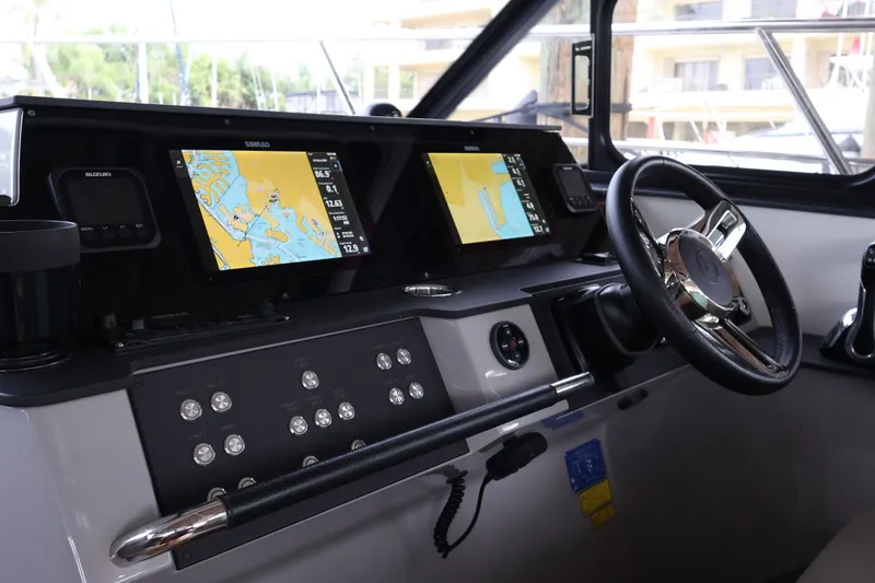 Slide: The Image of 2024 Aquador 300 HT helm with dual navigation screens and modern controls. - 18