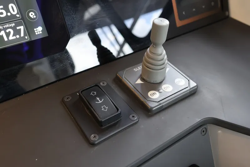 Slide: The Image of Control panel of 2024 Aquador 300 HT boat with joystick and anchor switch. - 20