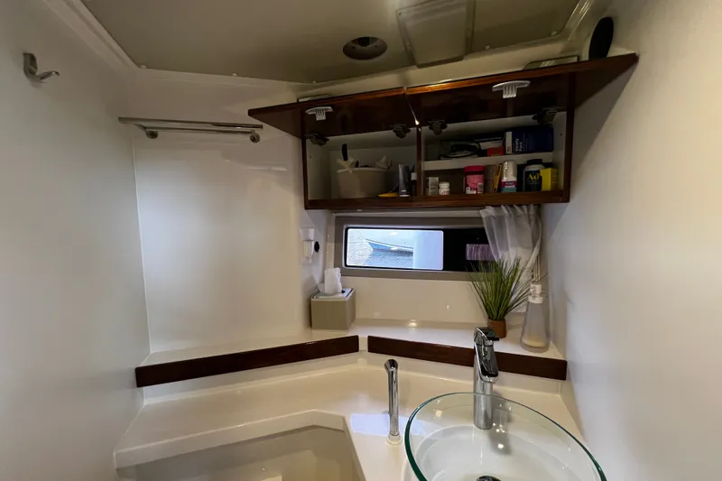Slide: The Image of Modern bathroom in 2024 Aquador 300 HT boat with glass sink and storage cabinets. - 56