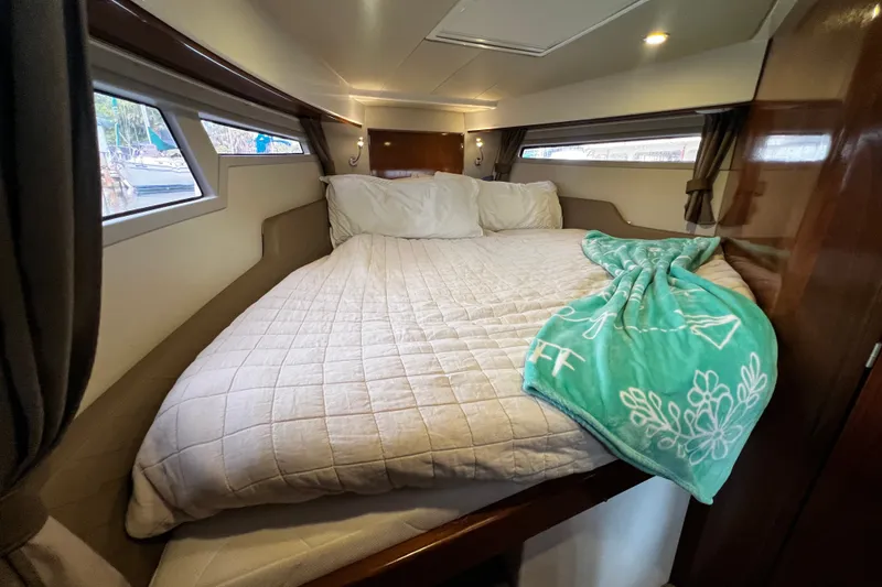 Slide: The Image of Luxurious cabin interior of 2024 Aquador 300 HT with cozy bedding and windows. - 45