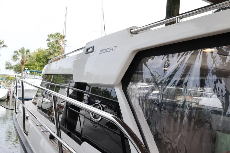 Slide: The Image of 2024 Aquador 300 HT yacht docked, showcasing sleek design and modern features. - 59