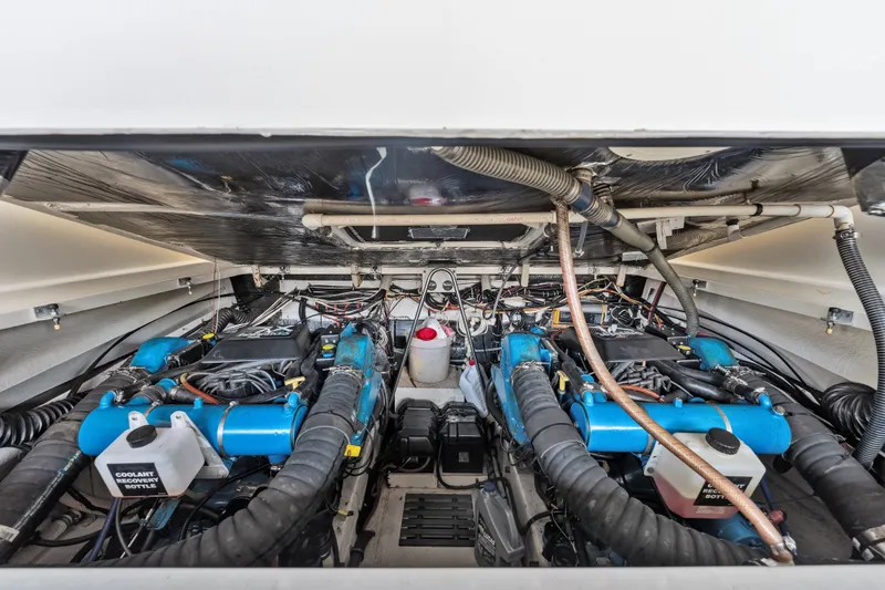 Slide: The Image of Engine compartment of a 1995 Pursuit 3000 Offshore boat, showcasing dual engines and components. - 68