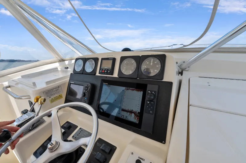 Slide: The Image of Helm of 1995 Pursuit 3000 Offshore boat with navigation instruments and steering wheel. - 17