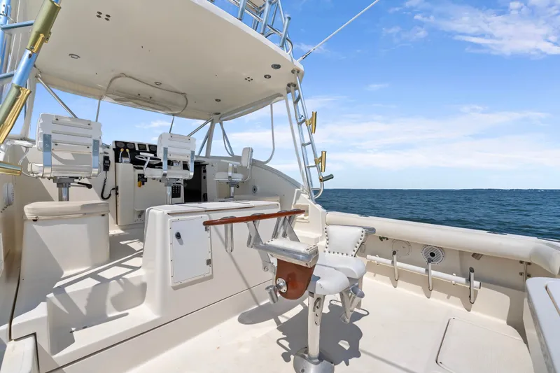 Slide: The Image of 1995 Pursuit 3000 Offshore boat interior with ocean view, featuring helm and seating area. - 19