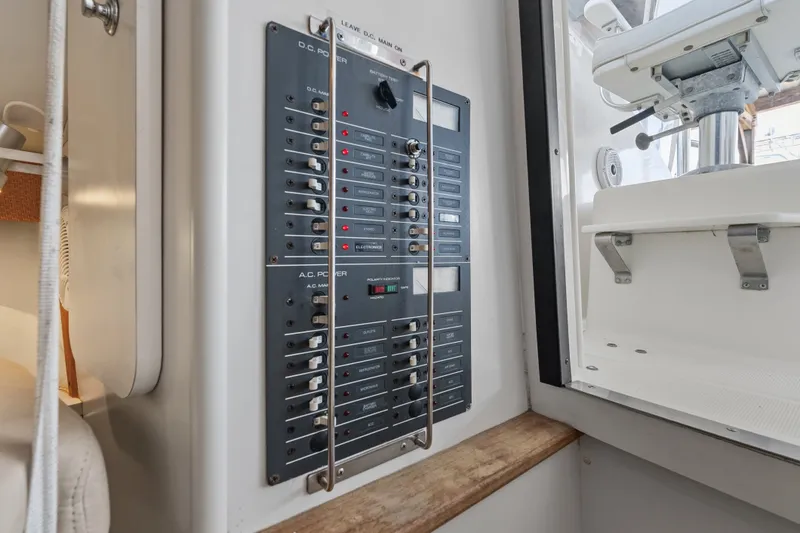 Slide: The Image of Electrical panel on a 1995 Pursuit 3000 Offshore boat, showcasing switches and controls. - 64