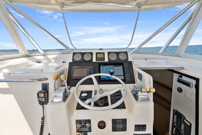 Slide: The Image of Helm of 1995 Pursuit 3000 Offshore boat with steering wheel and navigation instruments. - 16