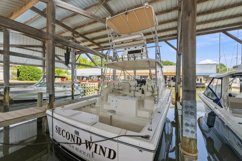 Slide: The Image of 1995 Pursuit 3000 Offshore boat docked in marina, named "Second Wind," Palm Beach, FL. - 34