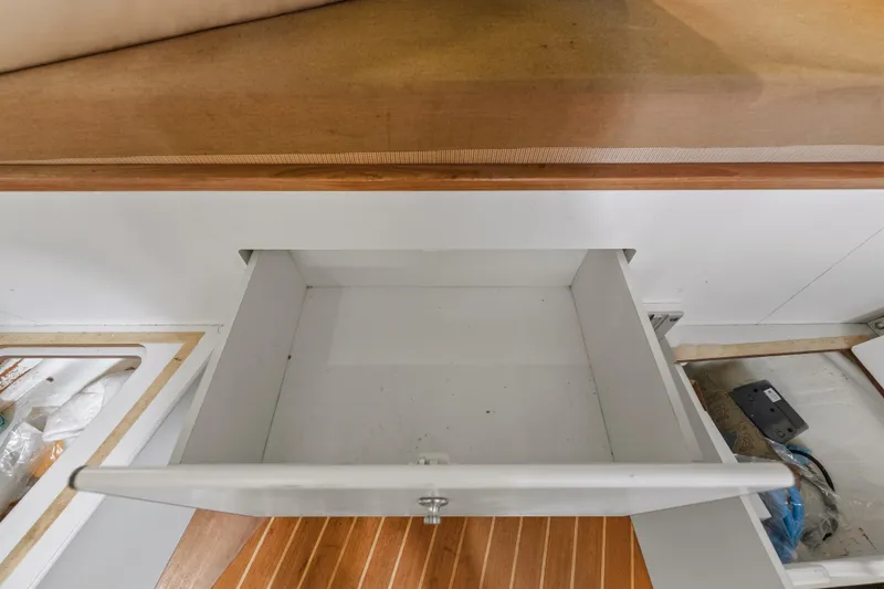 Slide: The Image of Open drawer in 1995 Pursuit 3000 Offshore boat interior, showcasing storage space. - 15